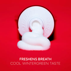 Tube of Colgate optic white pro series toothpaste with white paste on red background freshens breath cool wintergreen taste