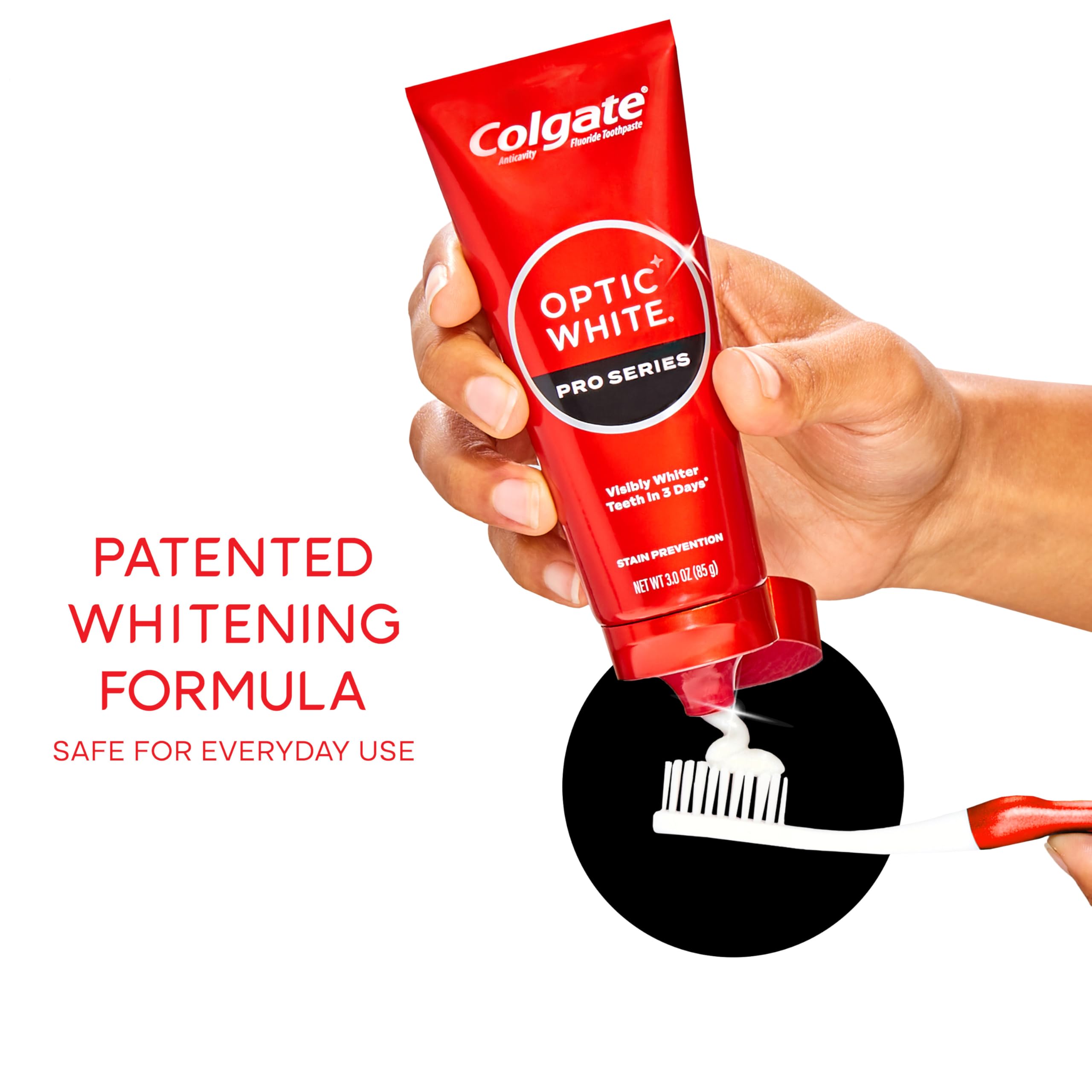 Hand holding Colgate optic white pro series toothpaste tube dispensing paste onto toothbrush illustrating whitening formula