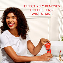 Woman holding a red Optic White Pro Series whitening toothpaste tube