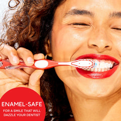 Smiling woman brushing teeth with red toothbrush using Colgate optic white pro series toothpaste for enamel safe whitening