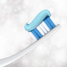 Toothpaste gel on a toothbrush with blue bristles