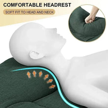 Green folding camping cot with contoured headrest cushion and padded fabric surface