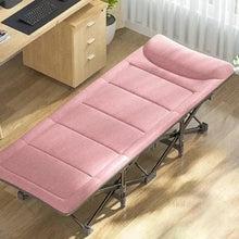 Folding camping cot with pink cushioned mattress on a folding metal frame
