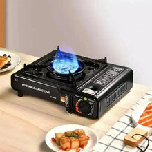 Portable gas stove with lit blue flame burner, black housing and control knob