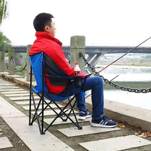 Folding camping chair with red back and blue seat panels, black steel frame
