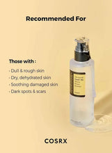 Skincare essence bottle with silver pump and black label on display