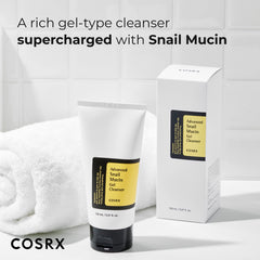 COSRX Advanced Snail Mucin Gel Cleanser tube and box next to a white towel on a bathroom counter
