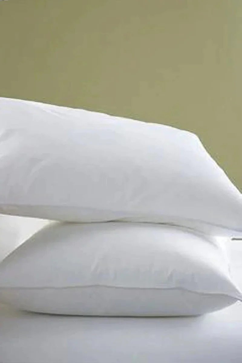 Huitich white cotton bed pillows set stacked on a bed with smooth fabric surface