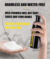 Hand holding black bottle dispensing waterless shoe cleaning foam onto another hand