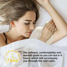 Fleece-covered hot water bottle held to neck and shoulder for warmth