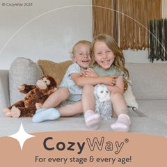 Two kids wearing CozyWay grip socks for kids 1-9 years sitting on a couch with soft toys smiling