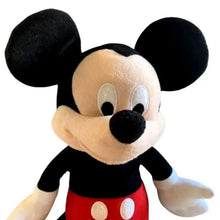 Plush Mickey Mouse toy face, black ears, red shorts, and white belly