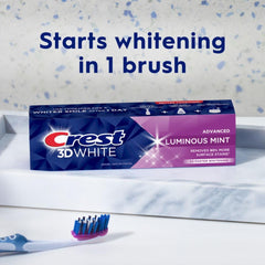 Crest 3D White toothpaste Advanced Luminous Mint box on bathroom counter with toothbrush