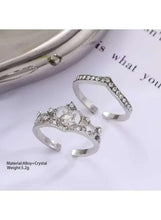 Crystal crown and band ring set in silver tone, shown from side angle with clear stone band
