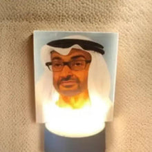 Portrait lamp shade with illustrated bearded face and warm glowing light