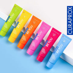 Bright row of six colorful tubes of Curaprox Be You gentle whitening toothpaste arranged diagonally