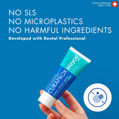 Hand holding Curaprox Enzycal 1450 toothpaste UAE tube on blue background with No SLS No microplastics message