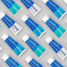 Curaprox Enzycal 1450 toothpaste tubes in teal-and-white packaging, multiple units.