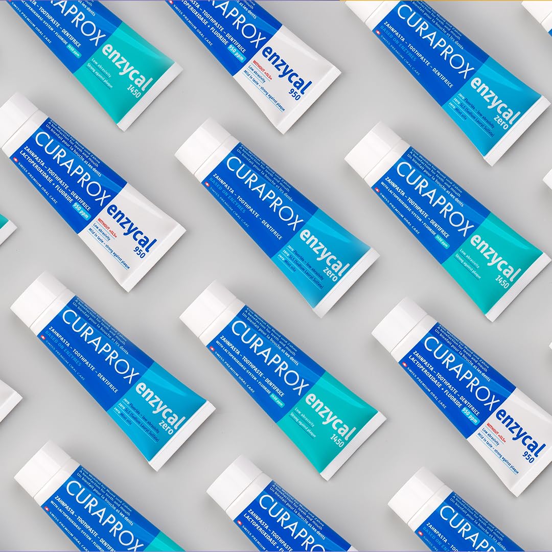 Curaprox Enzycal 1450 toothpaste UAE multiple blue and teal tubes arranged on a gray background