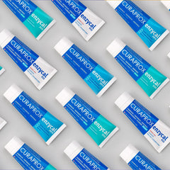 Curaprox Enzycal 1450 toothpaste UAE multiple blue and teal tubes arranged on a gray background