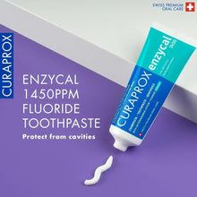 Curaprox Enzycal 1450 fluoride toothpaste tube with toothpaste smear and nozzle.