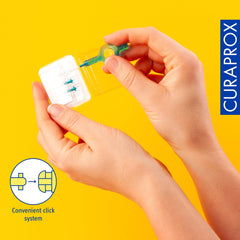 Curaprox interdental brushes starter set shown in hands with clear case and convenient click system
