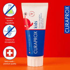 Curaprox kids fluoride toothpaste strawberry flavor tube on red background with Swiss made label and no microplastics