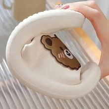 White plush slipper interior with stitched bear face patch
