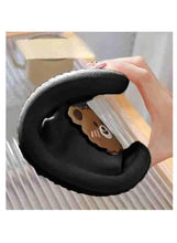 Close-up of dark slipper interior with bear-face patch detail