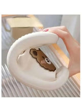 White slipper with bear face patch on inside, cushioned footbed and loop handle