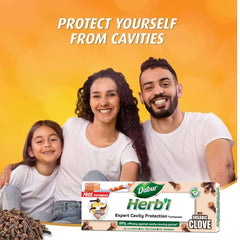 Dabur family photo with Herbl toothpaste box and cloves in foreground clove toothpaste for cavity protection