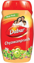Dabur Chyawanprash herbal tonic jar, red cap and beige label with fruit and flower art