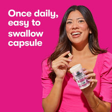 Women’s probiotic capsule bottle held by a woman, once daily easy-to-swallow capsules.