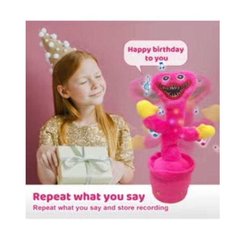Pink dancing cactus toy pink by Huitich with music and recording feature next to a girl holding a gift