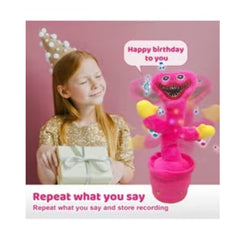 Pink dancing cactus toy pink by Huitich with music and recording feature next to a girl holding a gift