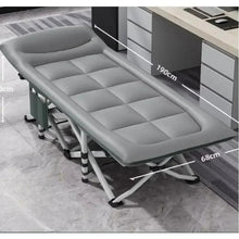 Foldable dark gray camp cot with padded mattress and black-and-white striped support legs