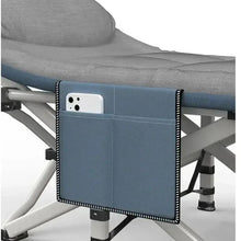 Dark gray camp cot with side panel pocket and stitched border on the mattress