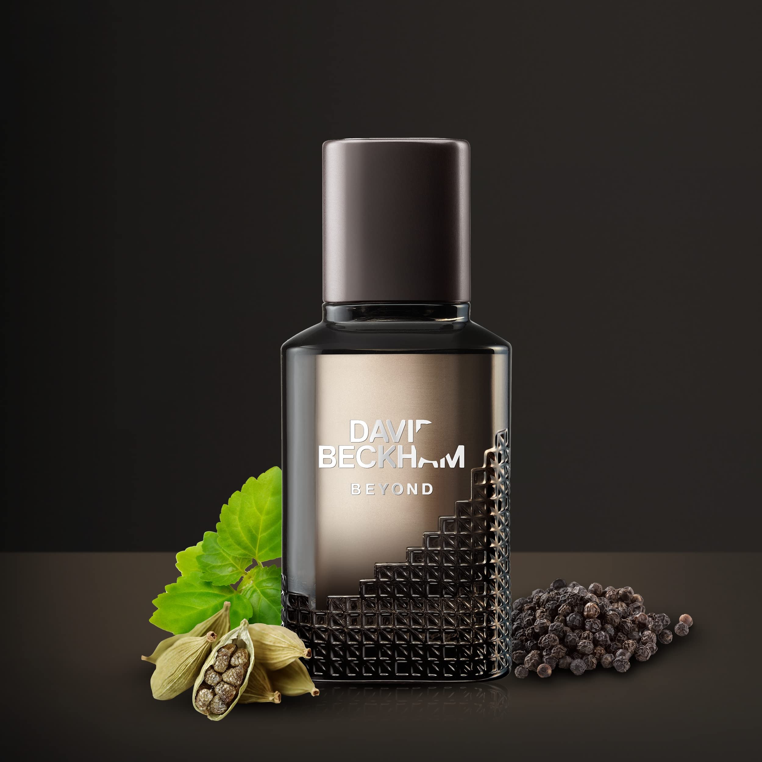 David Beckham Beyond perfume for men bottle with cardamom pods green leaf and black peppercorns