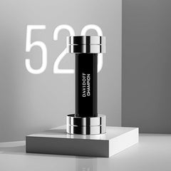 Davidoff Champion for men fragrance bottle designed like a black and silver dumbbell on a white pedestal