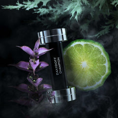 Davidoff Champion for men black bottle with silver cap beside lime slice and purple flowers on dark smoky background