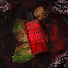 Davidoff Hot Water perfume for men in red bottle surrounded by green leaves and natural rocks