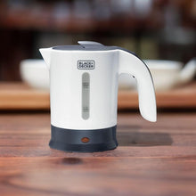White travel kettle with dark base, handle, spout, and water level markings