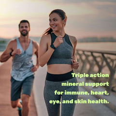 Smiling woman jogging on a bridge with a male runner at sunset lifestyle image promoting zinc 50mg capsules for immune support