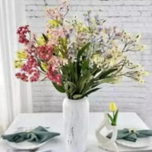Faux flower bouquet with pink, yellow, and green blooms in a vase