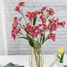 Artificial red flower bouquet arranged in a clear vase