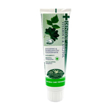 Nighttime toothpaste tube, white and green with leaf graphic and cross logo