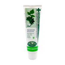 Nighttime toothpaste tube, green and white with leaf artwork and cross badge