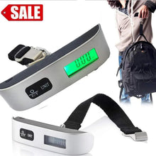 Silver digital luggage scale with green LCD and black strap for hanging bags