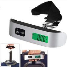 Digital luggage scale with green LCD display, black strap, and metal hook clip