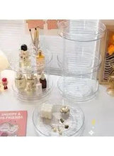 Clear rotating makeup organizer with round base and small beauty bottles
